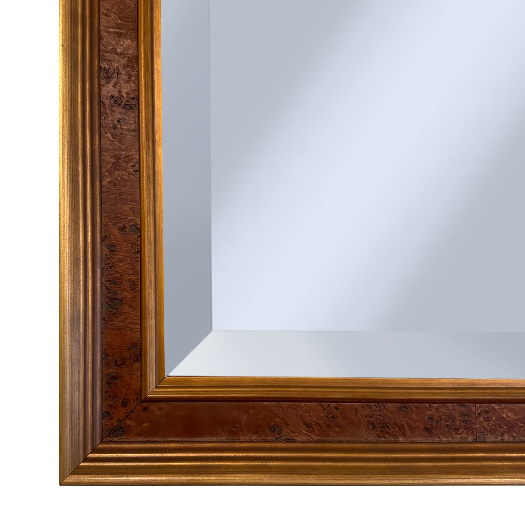 Wooden burl framed mirror with gold leafed edges on a white background
