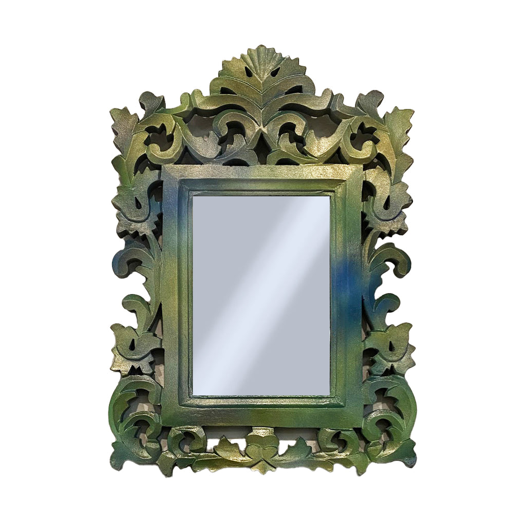 Decorative carved mirror with intricate green frame on a white background